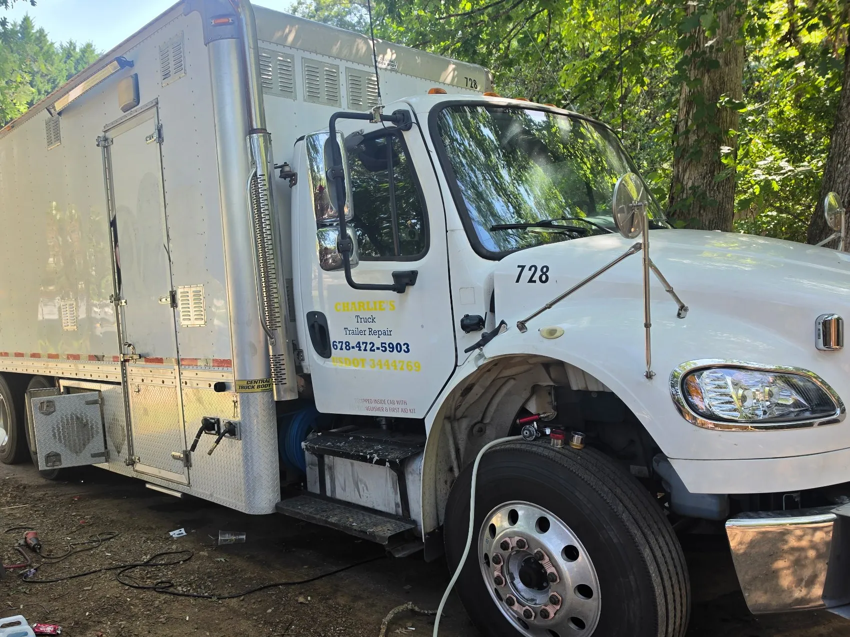 Charlie's mobile service truck with work lights on at a roadside breakdown